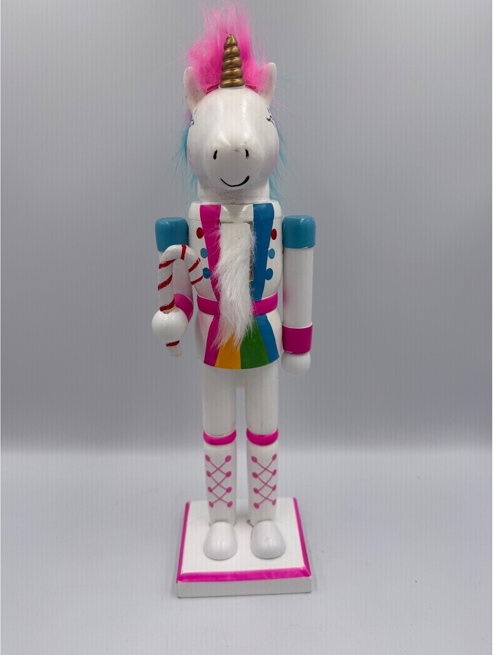 Beautiful decorative wooden unicorn nutcracker with a gold horn